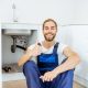 Handsome plumber at the kitchen